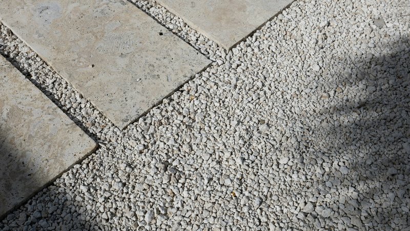 Stone pavers set into a prepared pale gravel surface